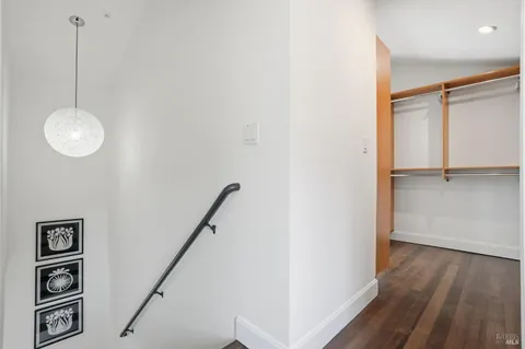 a view of a hallway with entryway wooden floor and front door