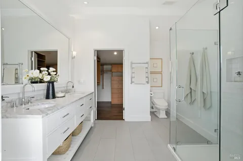 a bedroom with a bed and glass window