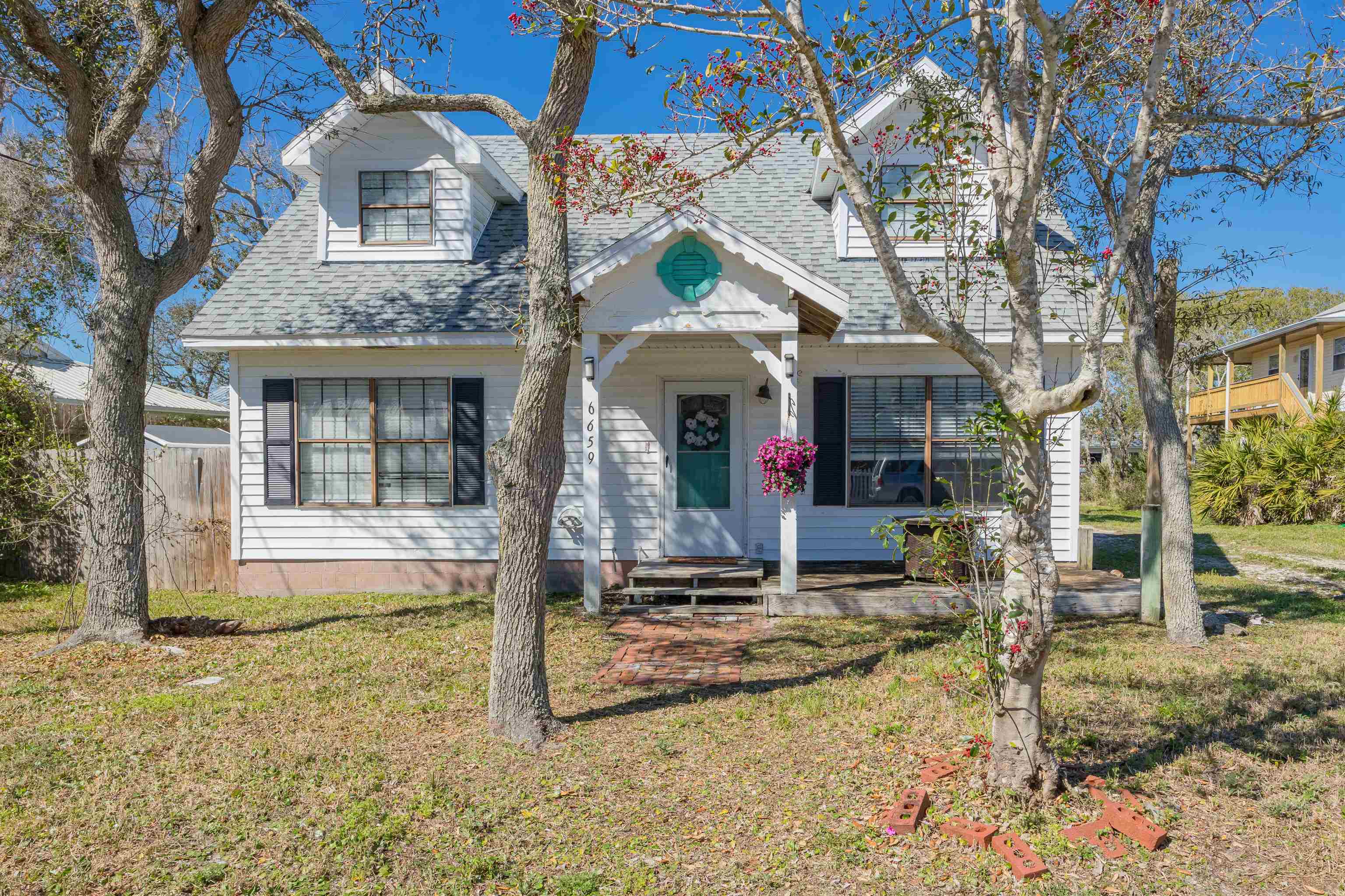 6659 Brevard Street St. Augustine, FL 32080 - Photo 4 of 27 a front view of a house with garden