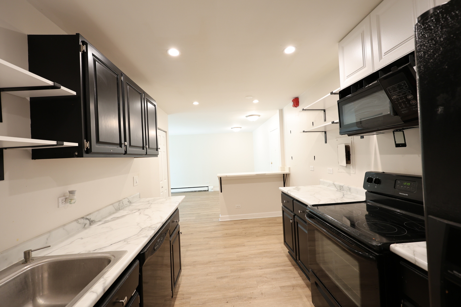 2230 South Goebbert Road, Unit 139 Arlington Heights, IL 60005 - Photo 10 of 14 a kitchen with granite countertop stainless steel appliances and sink