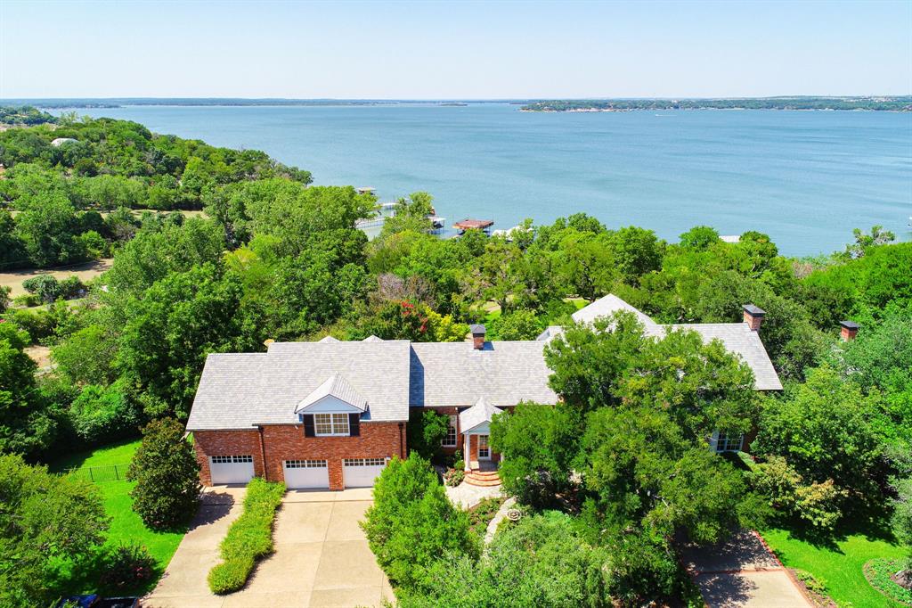8055 Eagle Mountain Circle Fort Worth, TX 76135 - Photo 1 of 40 an aerial view of a house with garden space and outdoor seating