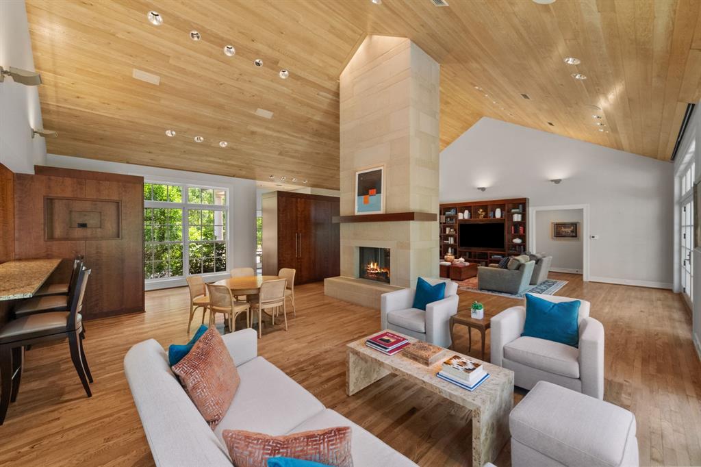 8055 Eagle Mountain Circle Fort Worth, TX 76135 - Photo 16 of 40 a living room with furniture a fireplace and a flat screen tv