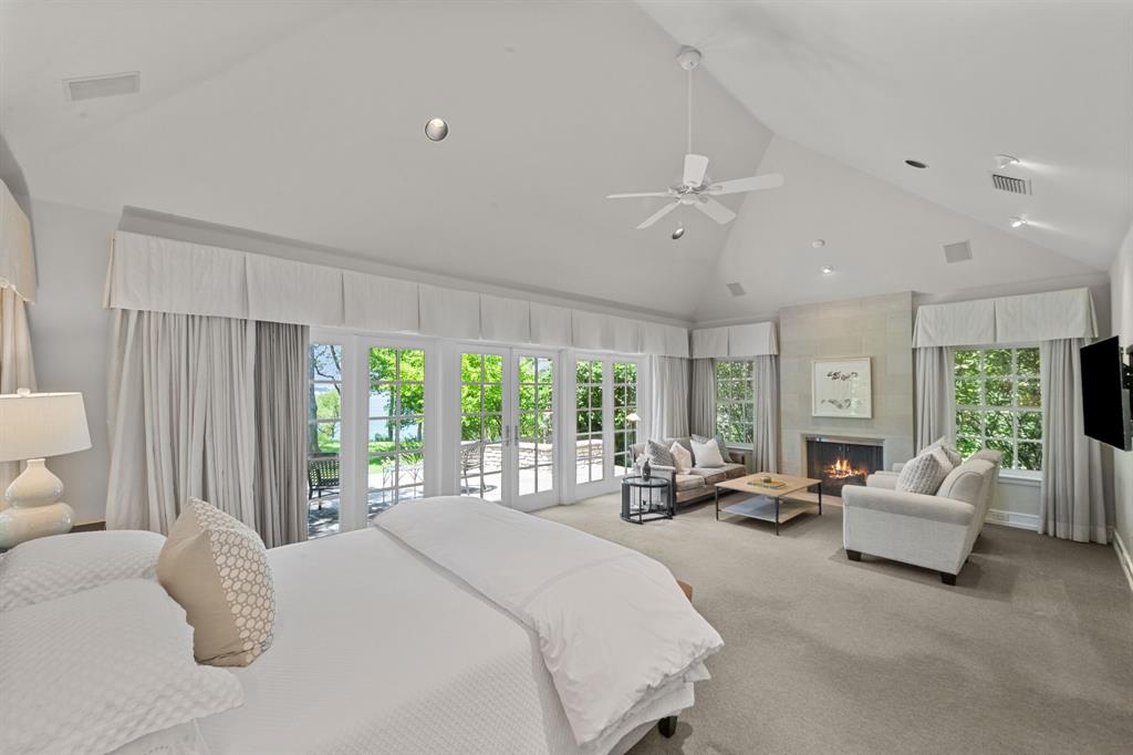 8055 Eagle Mountain Circle Fort Worth, TX 76135 - Photo 19 of 40 a spacious bedroom with a bed and large windows