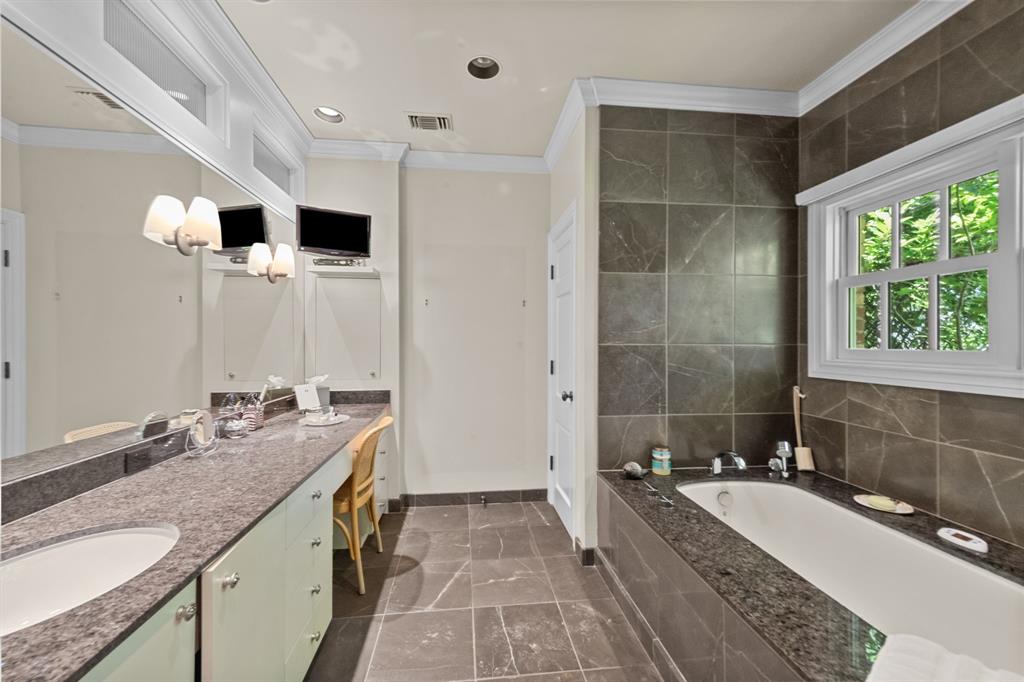 8055 Eagle Mountain Circle Fort Worth, TX 76135 - Photo 21 of 40 a bathroom with a granite countertop double vanity sink a mirror and a bathtub