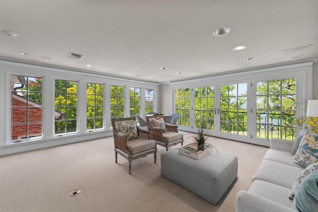 8055 Eagle Mountain Circle Fort Worth, TX 76135 - Photo 29 of 40 a living room with furniture and floor to ceiling windows