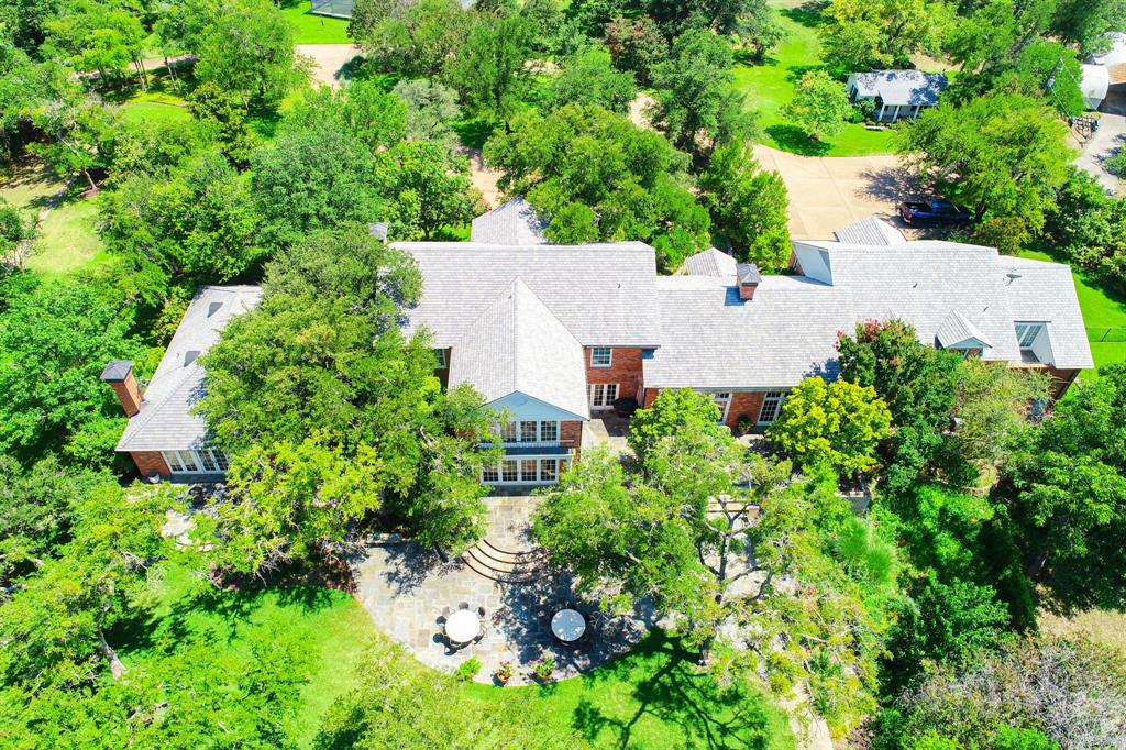 8055 Eagle Mountain Circle Fort Worth, TX 76135 - Photo 3 of 40 an aerial view of a house with a yard and large trees