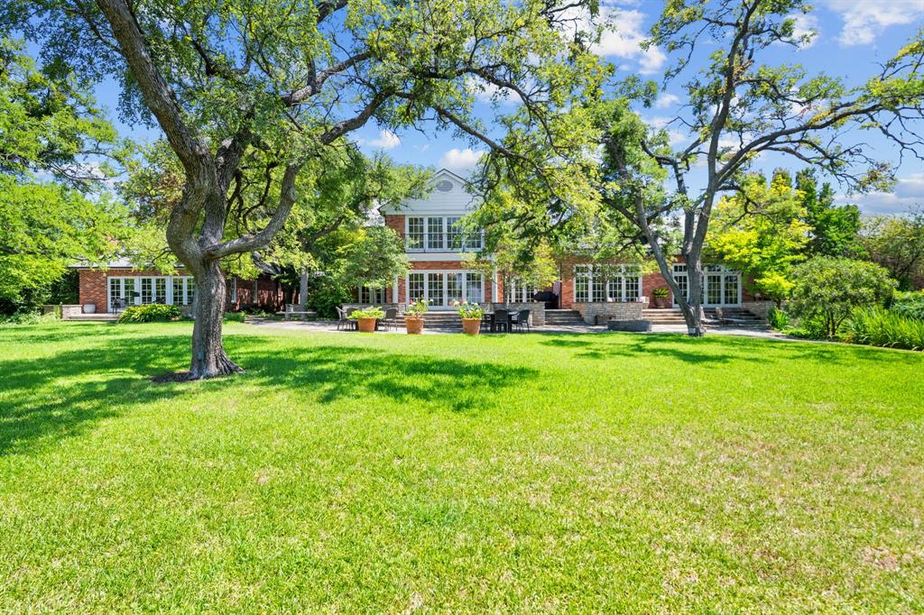 8055 Eagle Mountain Circle Fort Worth, TX 76135 - Photo 33 of 40 a front view of a building with a garden