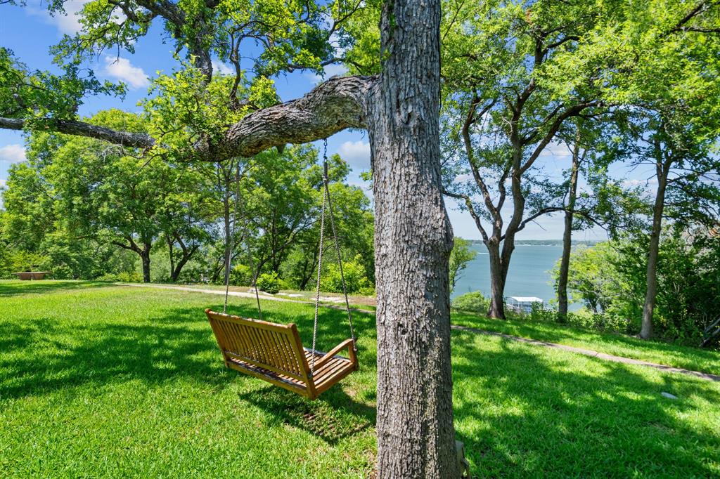 8055 Eagle Mountain Circle Fort Worth, TX 76135 - Photo 36 of 40 a view of a garden with a bench in a garden