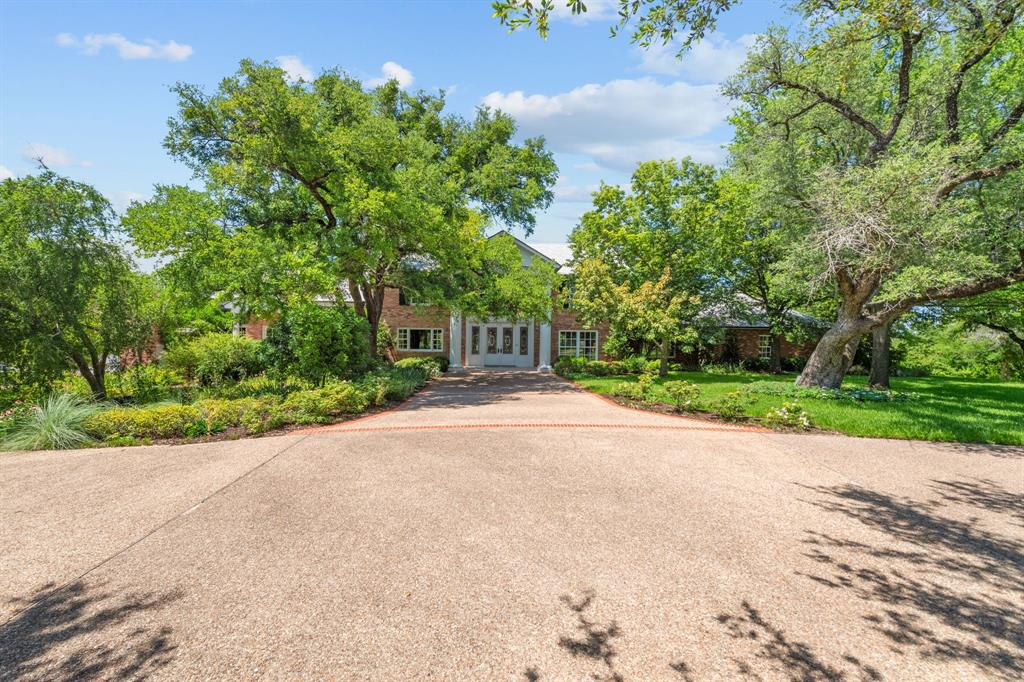 8055 Eagle Mountain Circle Fort Worth, TX 76135 - Photo 4 of 40 a view of a street with a house in the background