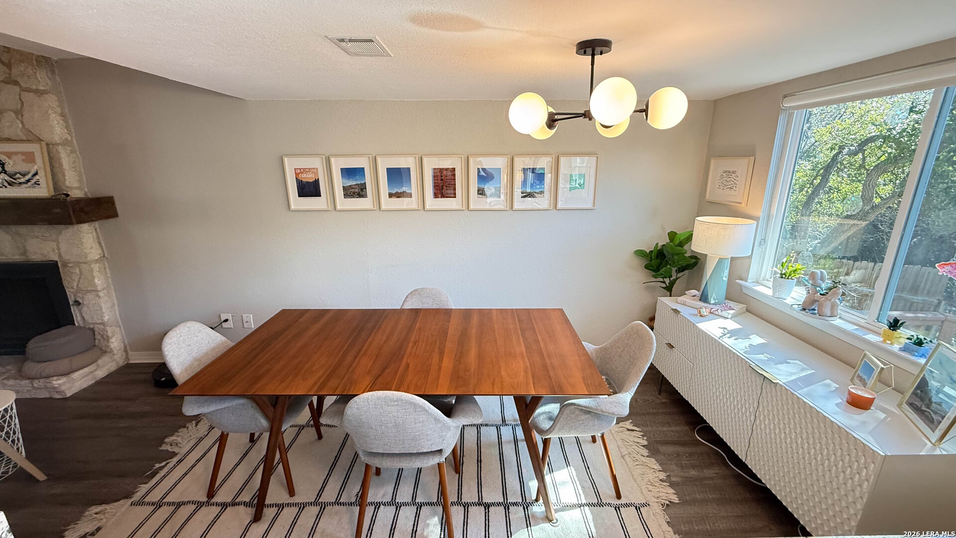 8505 Spring Valley Drive Austin, TX 78736 - Photo 11 of 49 a view of a dining room with furniture a potted plant and wooden floor