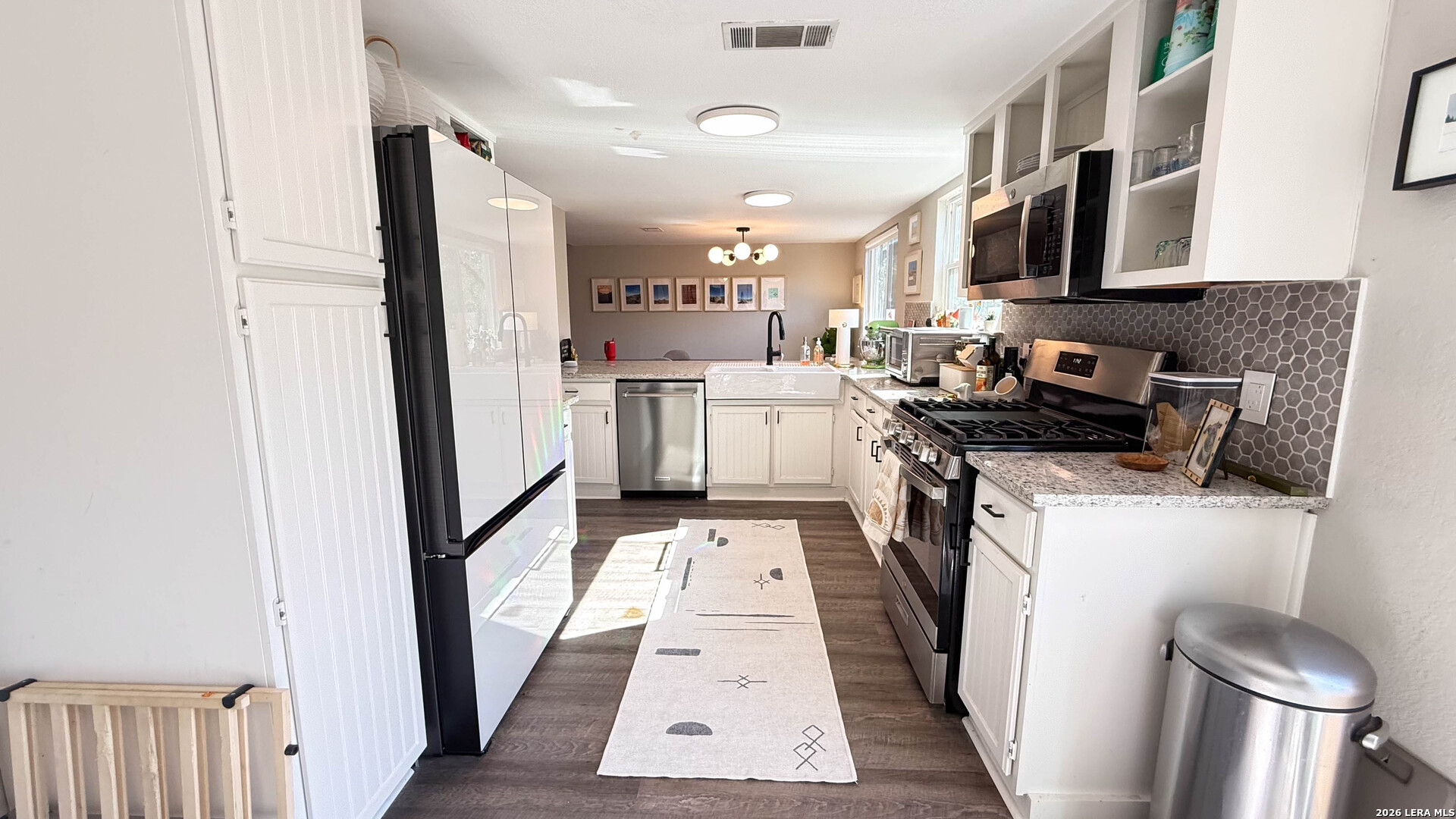 8505 Spring Valley Drive Austin, TX 78736 - Photo 16 of 49 a kitchen with a sink and a stove top oven
