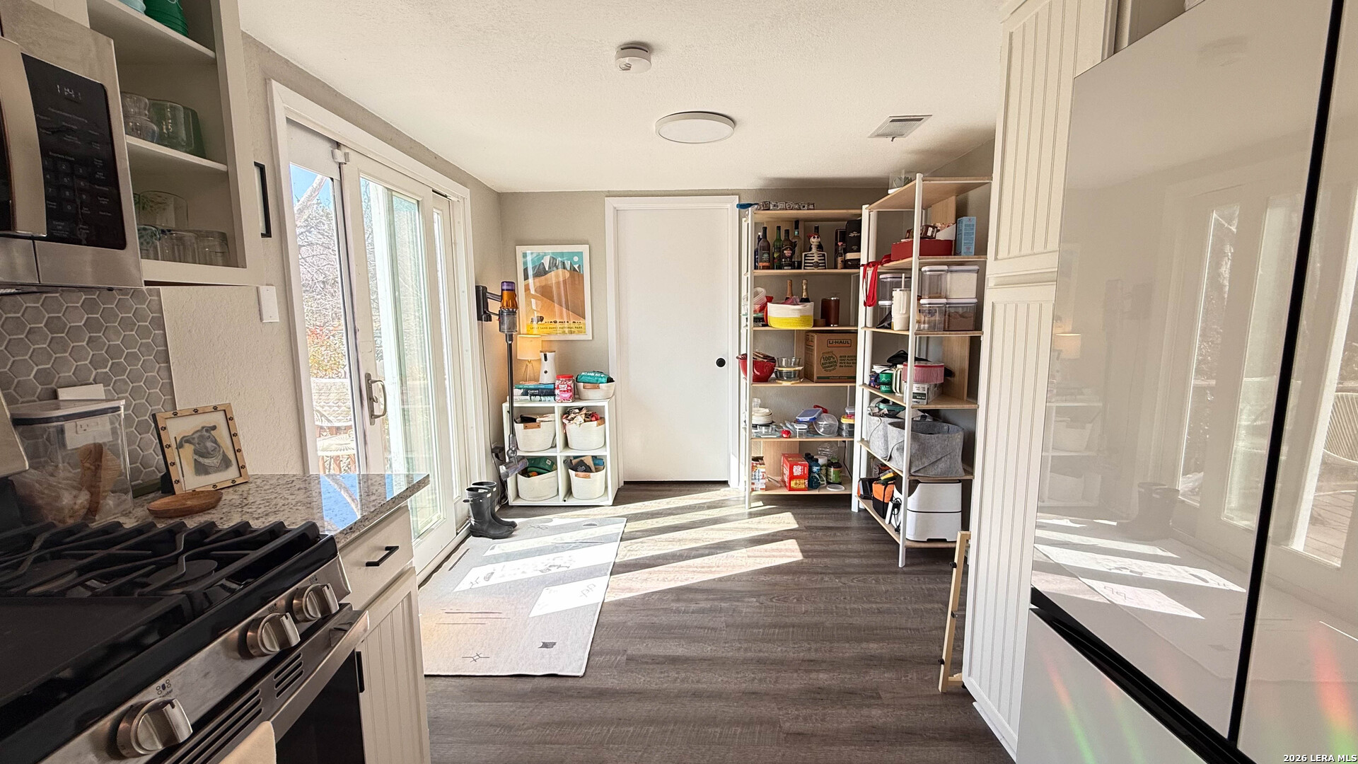 8505 Spring Valley Drive Austin, TX 78736 - Photo 17 of 49 a kitchen with stainless steel appliances granite countertop a stove and a refrigerator