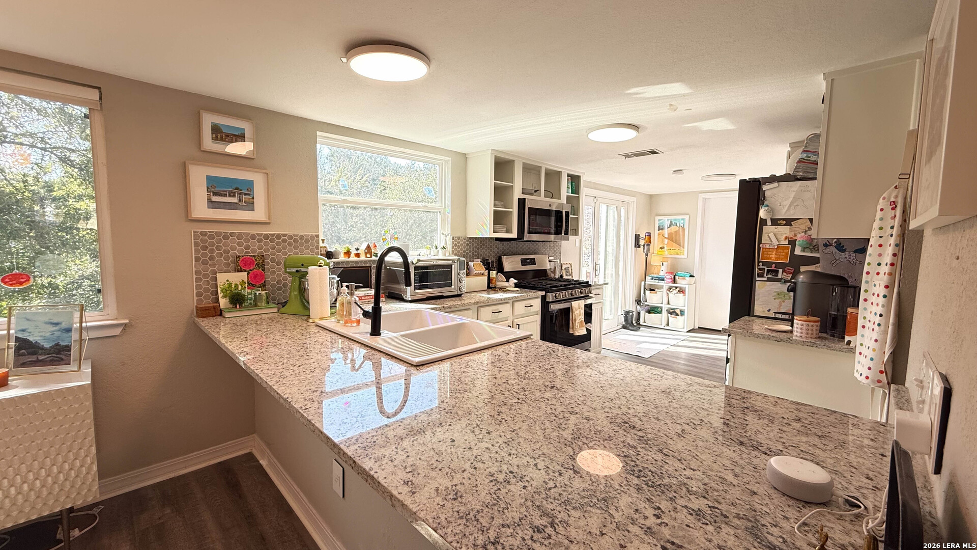 8505 Spring Valley Drive Austin, TX 78736 - Photo 19 of 49 a living room with stainless steel appliances furniture a rug kitchen view and a counter top space