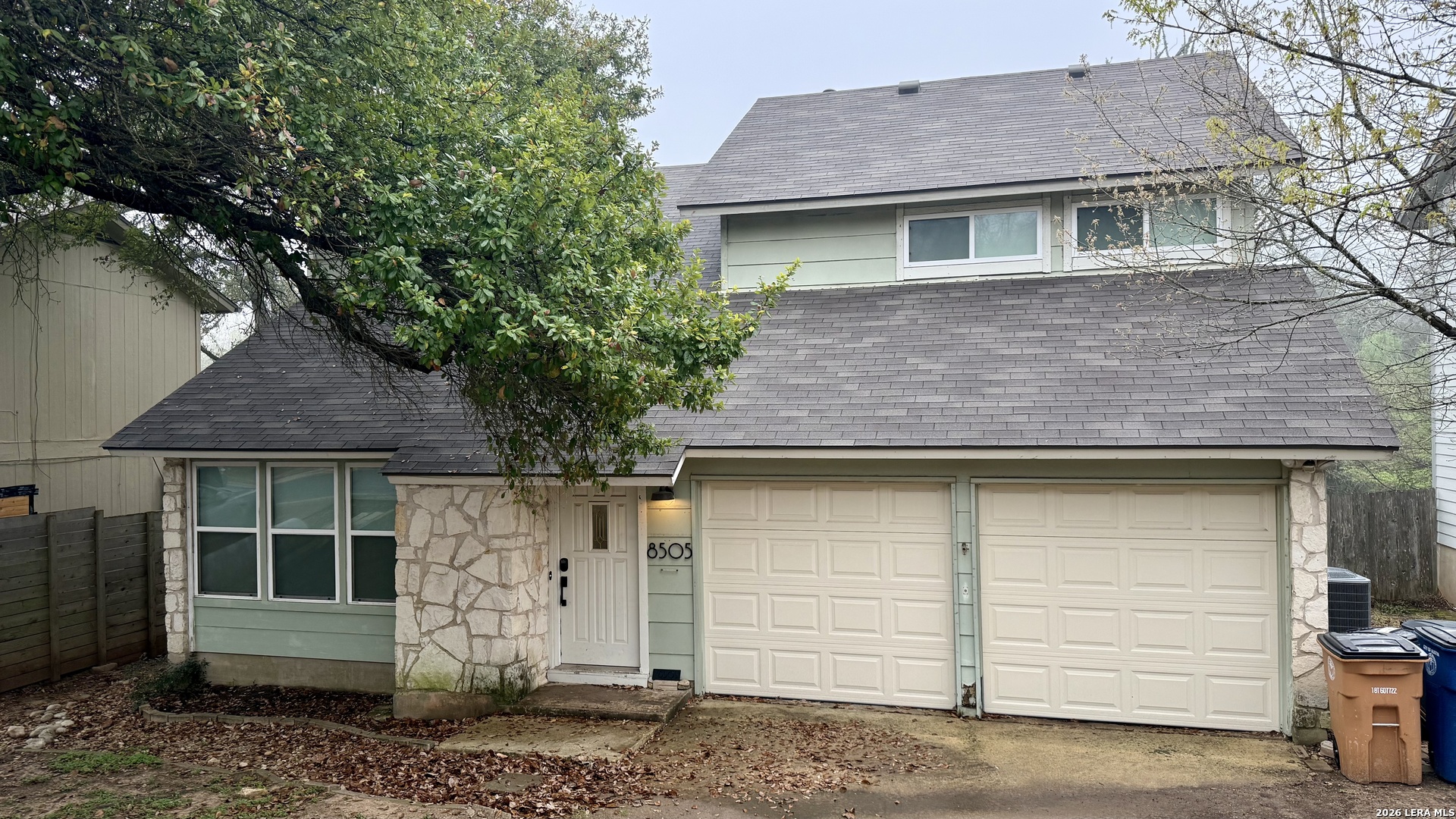 8505 Spring Valley Drive Austin, TX 78736 - Photo 2 of 49 a front view of a house with a yard and garage