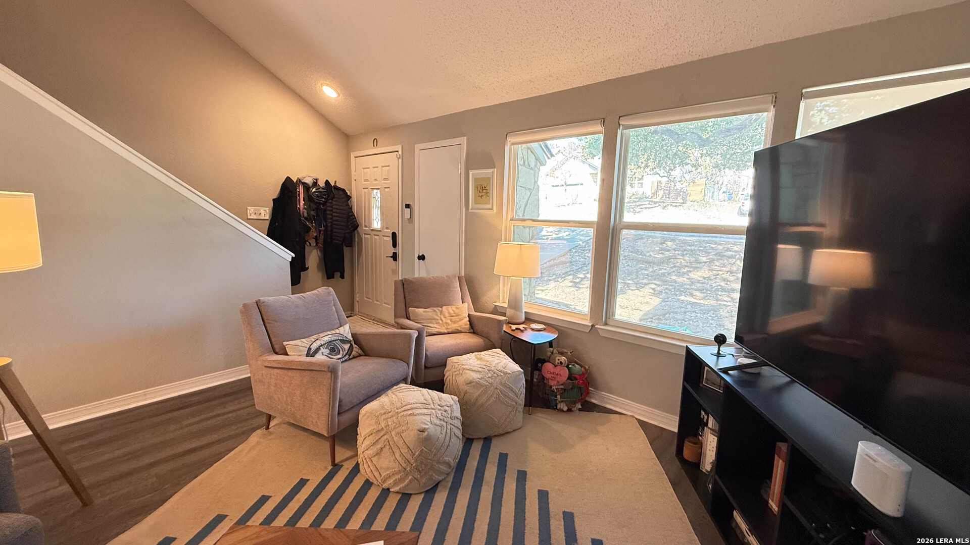 8505 Spring Valley Drive Austin, TX 78736 - Photo 23 of 49 a living room with furniture two large window and a flat screen tv