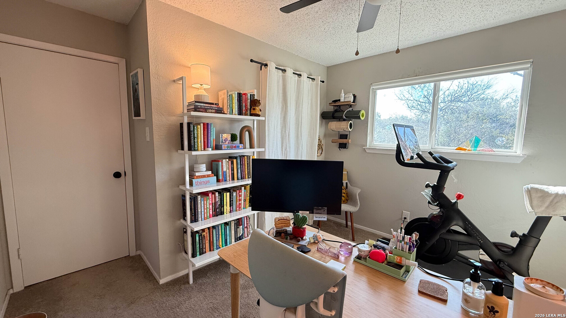 8505 Spring Valley Drive Austin, TX 78736 - Photo 35 of 49 a view of a workspace with furniture and a bookshelf