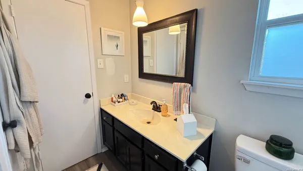 a bathroom with a sink vanity and a mirror