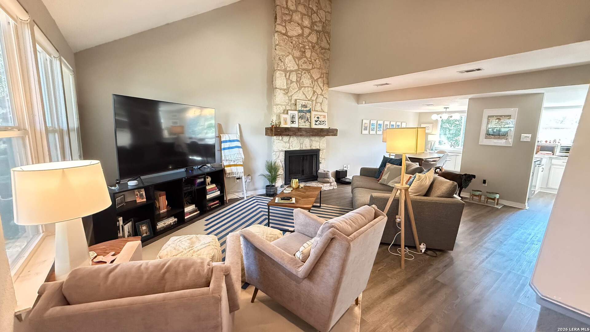 8505 Spring Valley Drive Austin, TX 78736 - Photo 6 of 49 a living room with furniture a fireplace and a flat screen tv