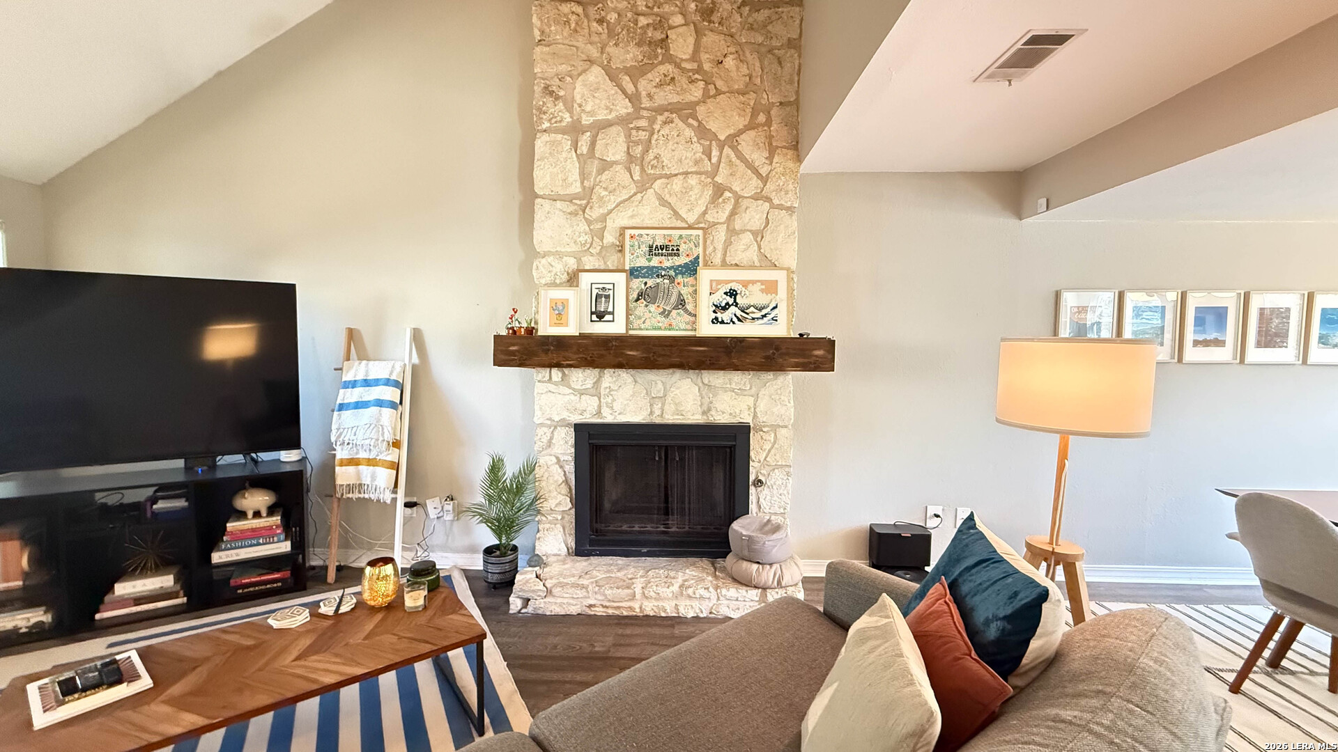 8505 Spring Valley Drive Austin, TX 78736 - Photo 9 of 49 a living room with furniture a flat screen tv and a fireplace
