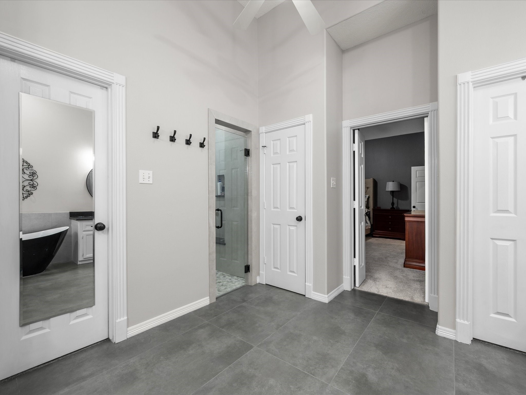 5910 Center Ct Drive Spring, TX 77379 - Photo 24 of 50 A spacious walk-in shower pairs with dual closets to create a highly functional and well-appointed primary suite designed with comfort and organization in mind.