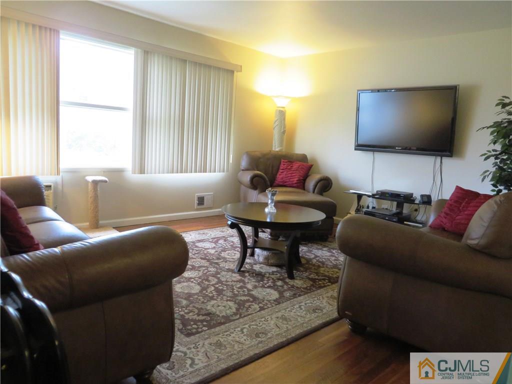 213 Princeton Road Old Bridge, NJ 08859 - Photo 2 of 17 a living room with furniture and a flat screen tv