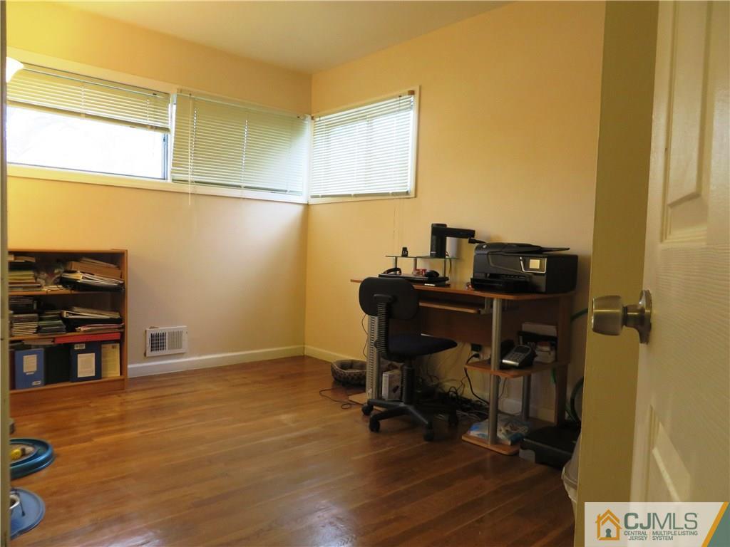 213 Princeton Road Old Bridge, NJ 08859 - Photo 12 of 17 a view of a workspace with furniture and wooden floor