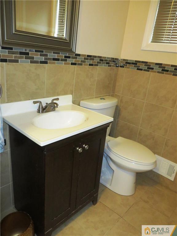 213 Princeton Road Old Bridge, NJ 08859 - Photo 14 of 17 a bathroom with a sink a toilet and a mirror