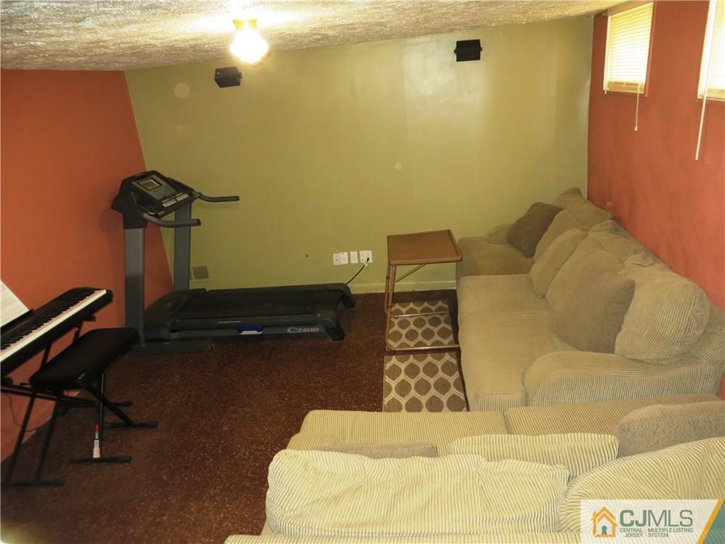 213 Princeton Road Old Bridge, NJ 08859 - Photo 16 of 17 a living room with couch and a table