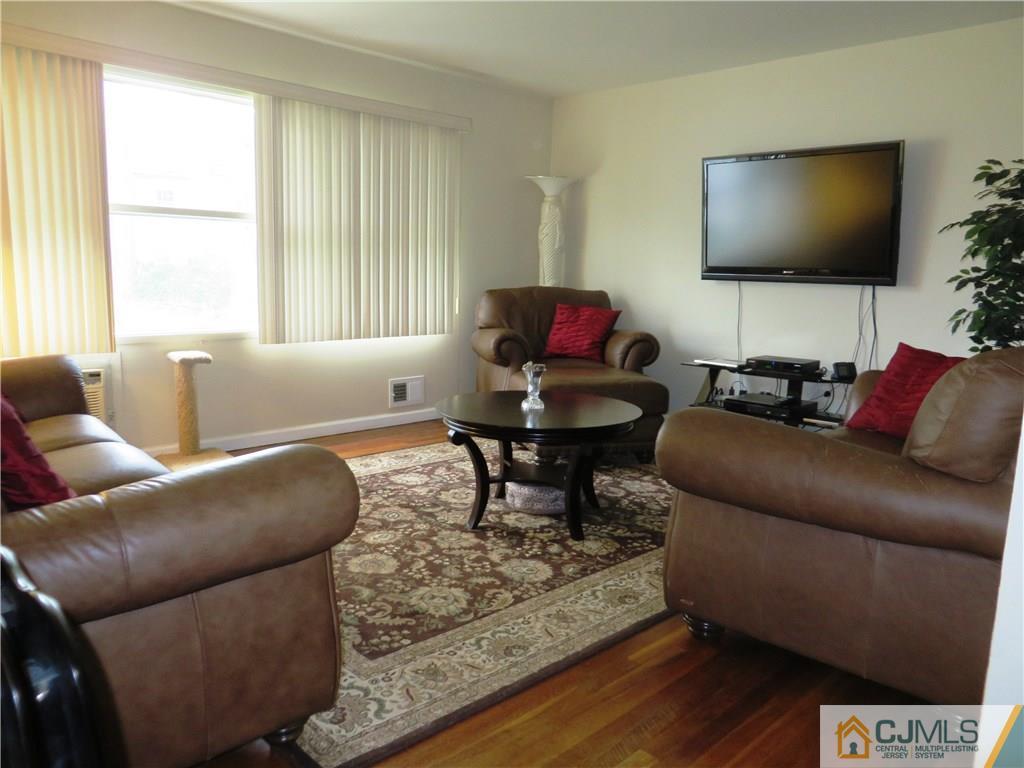 213 Princeton Road Old Bridge, NJ 08859 - Photo 3 of 17 a living room with furniture and a flat screen tv
