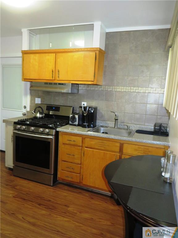 213 Princeton Road Old Bridge, NJ 08859 - Photo 4 of 17 a kitchen with stainless steel appliances granite countertop a stove a sink and a microwave