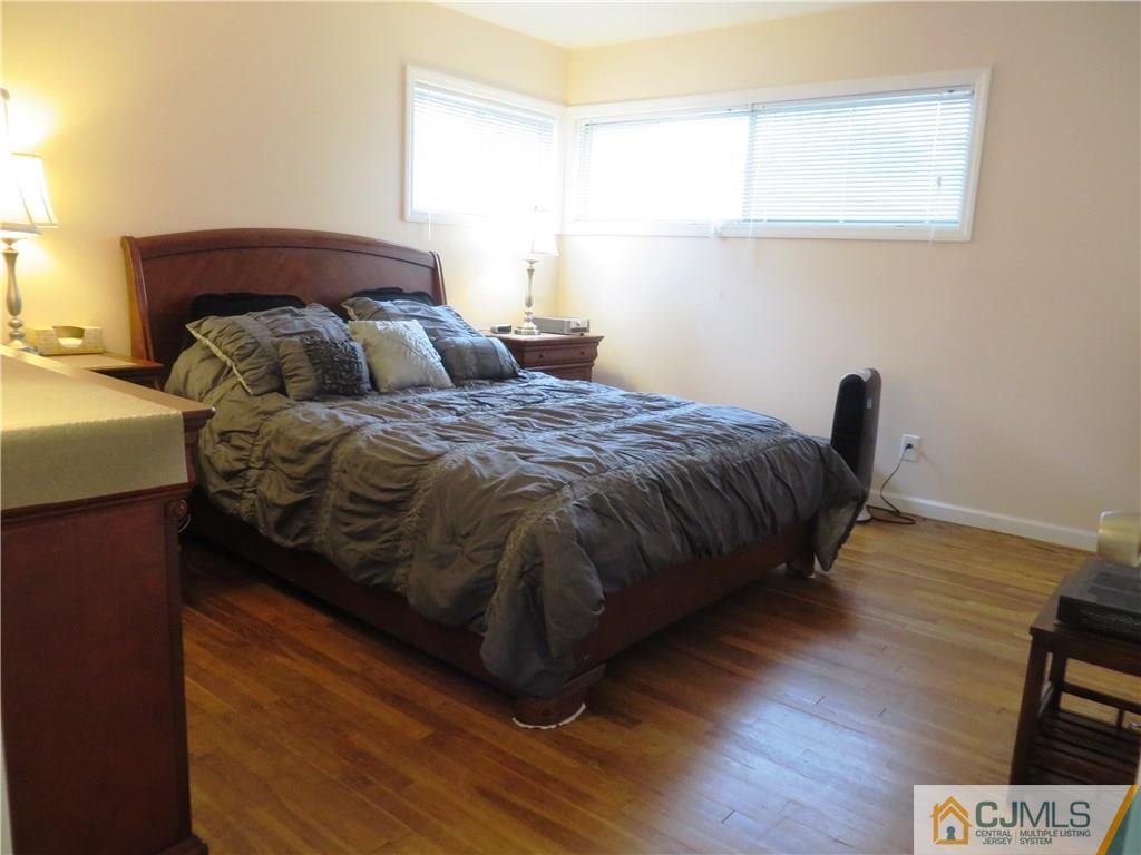 213 Princeton Road Old Bridge, NJ 08859 - Photo 6 of 17 a bed sitting in a bedroom next to a window
