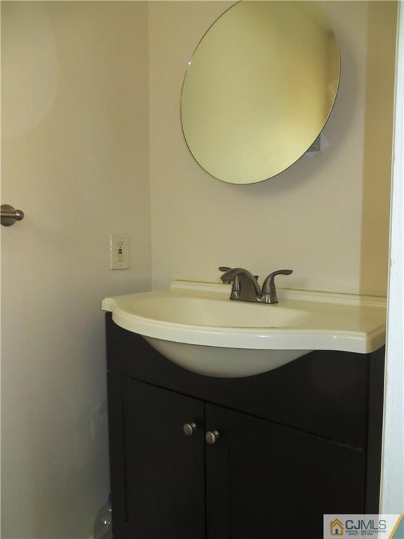 213 Princeton Road Old Bridge, NJ 08859 - Photo 9 of 17 a bathroom with a sink and a mirror