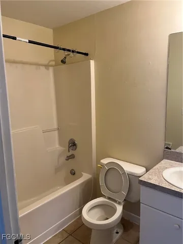 a bathroom with a granite countertop toilet sink and shower