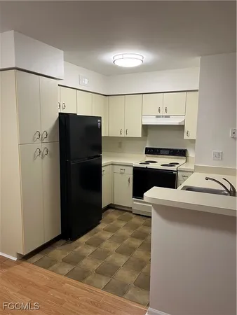 a kitchen with a refrigerator sink and stove