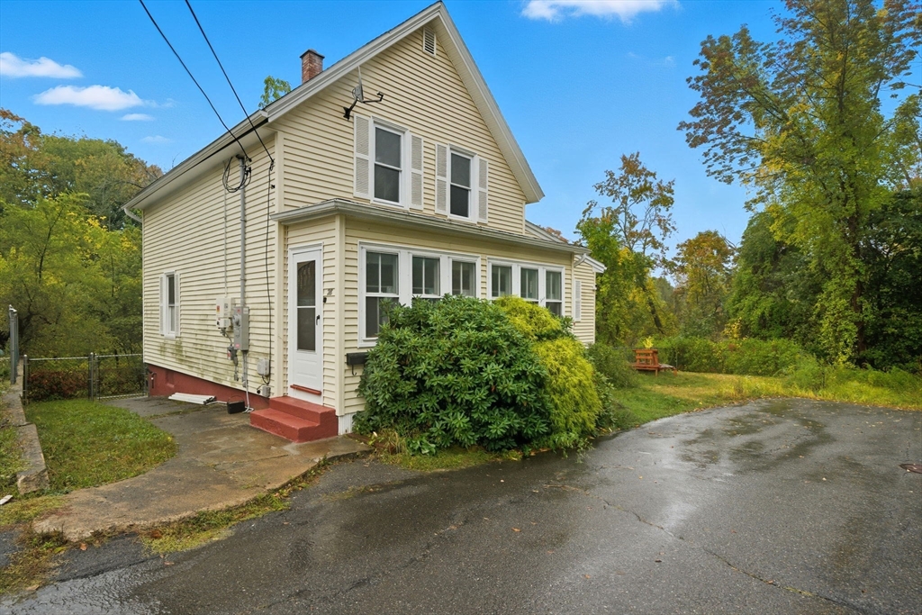 a front view of a house with garden
