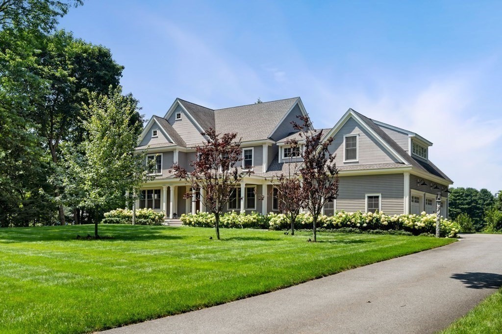 a front view of house with yard and green space