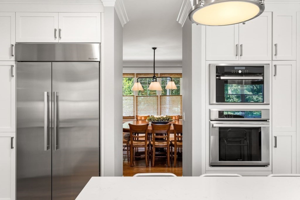1663 Lowell Road Concord, MA 01742 - Photo 11 of 41 a kitchen with a refrigerator and a sink