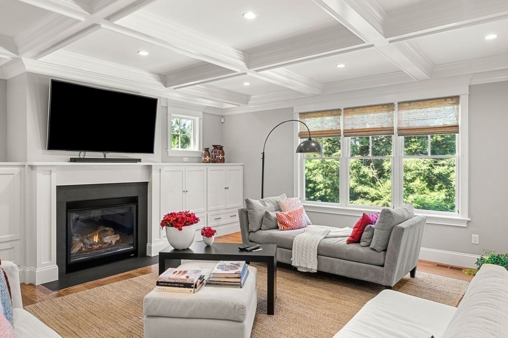1663 Lowell Road Concord, MA 01742 - Photo 16 of 41 a living room with furniture a flat screen tv and a fireplace