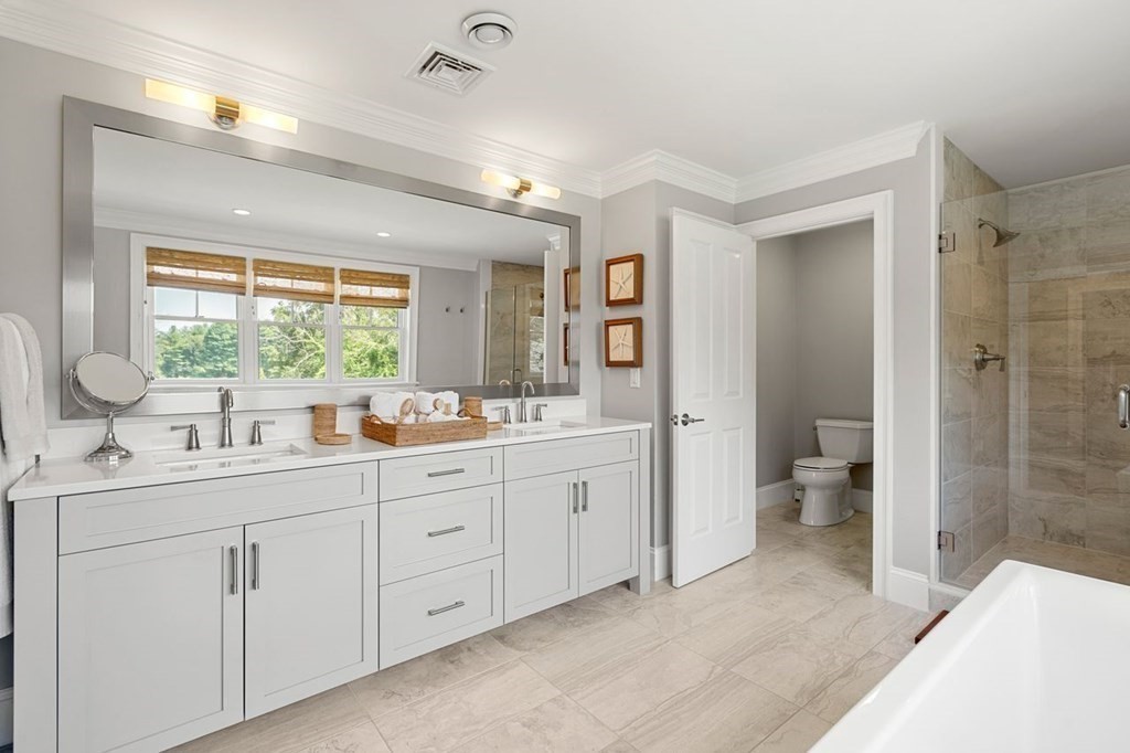 1663 Lowell Road Concord, MA 01742 - Photo 28 of 41 a spacious bathroom with a double vanity sink toilet and shower