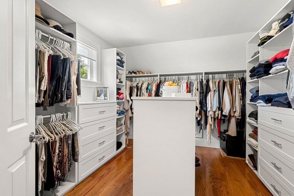 1663 Lowell Road Concord, MA 01742 - Photo 30 of 41 a view of walk in closet with clothes and shoes