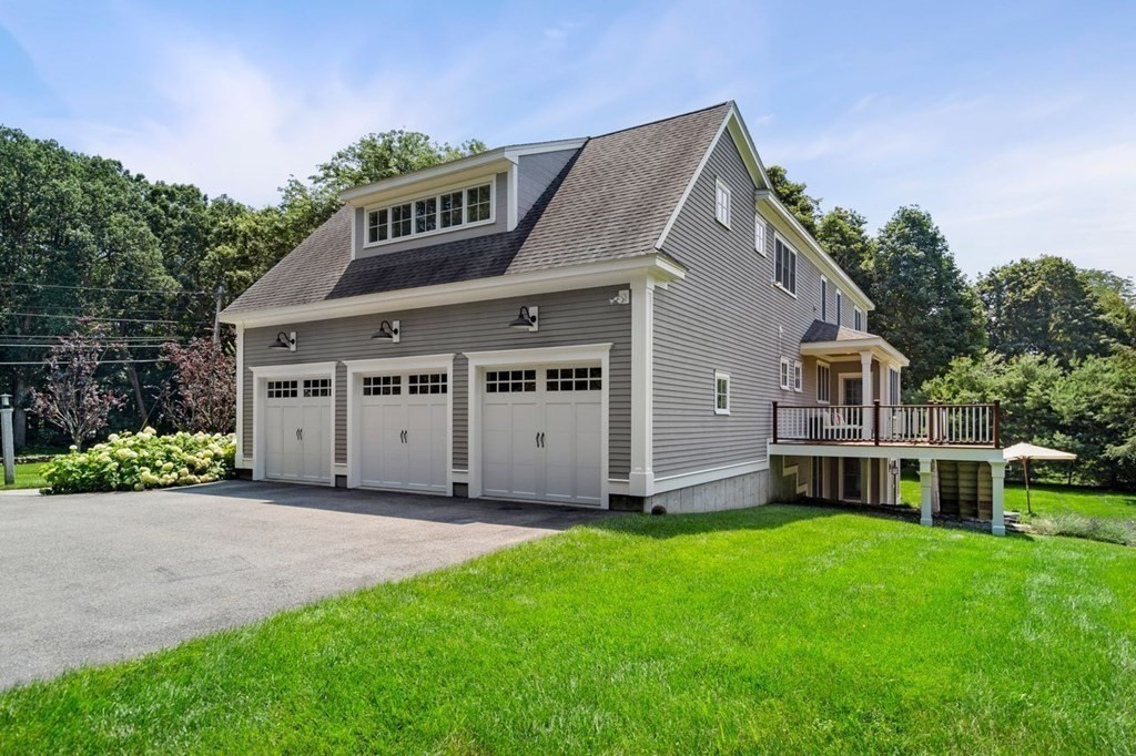 1663 Lowell Road Concord, MA 01742 - Photo 38 of 41 a front view of a house with a garden and deck