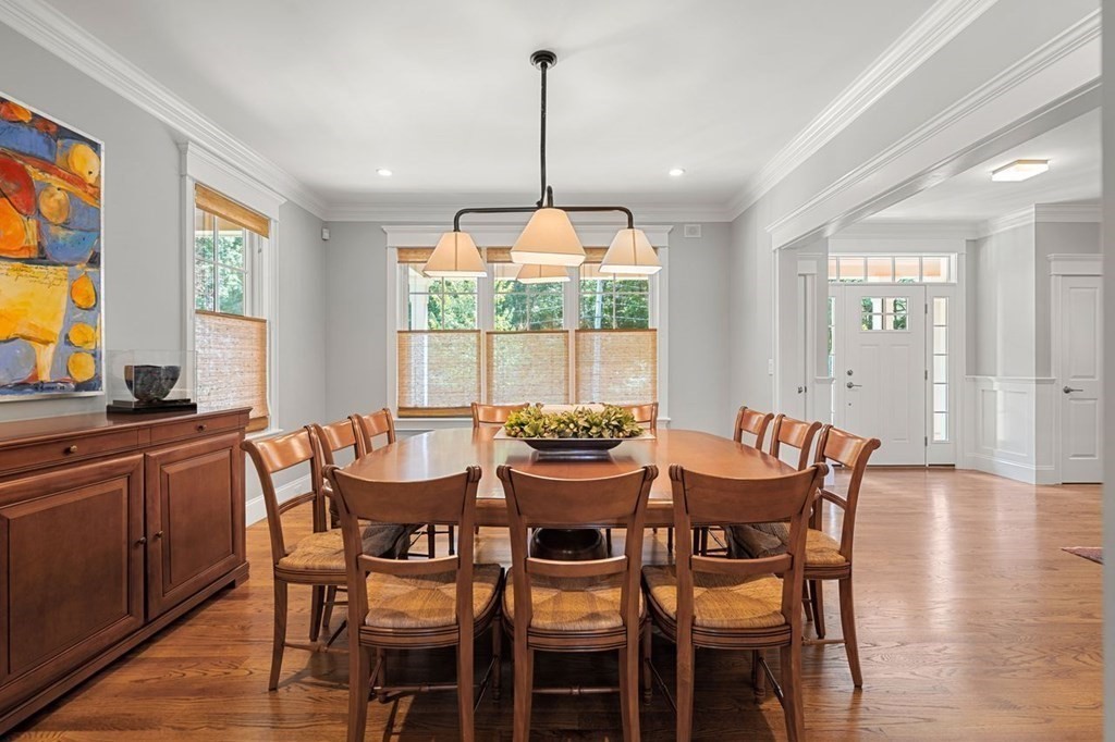 1663 Lowell Road Concord, MA 01742 - Photo 7 of 41 a dining room with furniture a chandelier and wooden floor