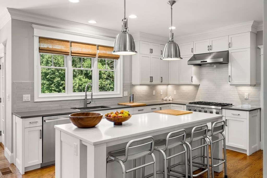 1663 Lowell Road Concord, MA 01742 - Photo 8 of 41 a kitchen with a stove a refrigerator and a wooden cabinets