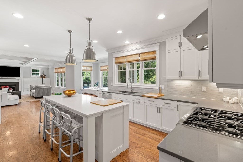 1663 Lowell Road Concord, MA 01742 - Photo 10 of 41 a kitchen with stove a sink and a wooden cabinets