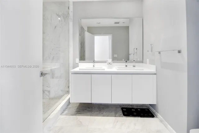 a bathroom with a shower and a sink