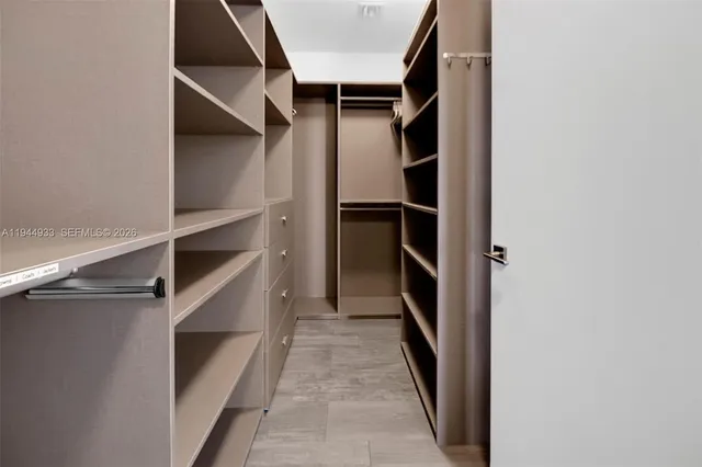 a view of a patio with couches and a table and chairs under an umbrella