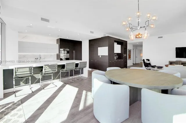 a view of kitchen with wooden floor and electronic appliances