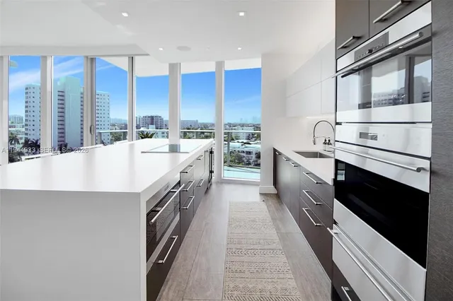 a living room with furniture and chandelier