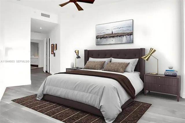 a bedroom with a bed and a painting on the wall