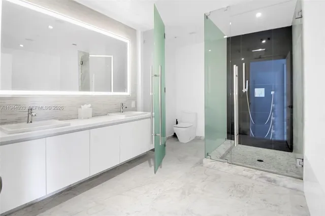 a spacious bathroom with a shower sink and mirror